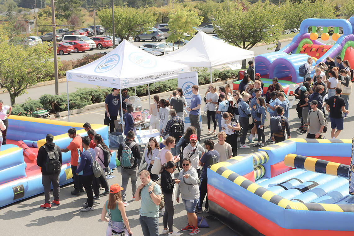 People enjoying a festival with bouncy castles